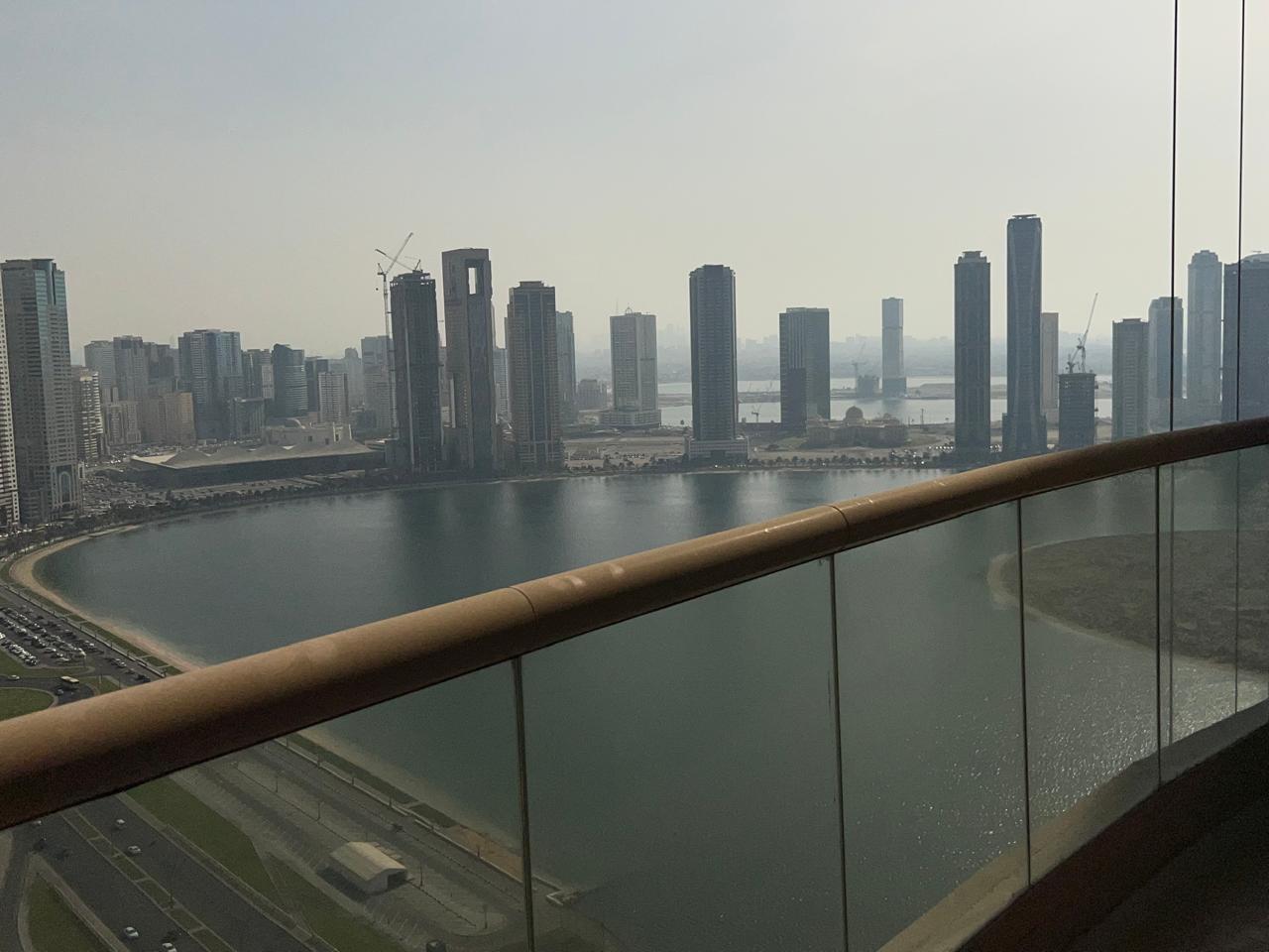Two-bedroom apartment with balcony and free AC in Al Qasba Khan, open view, gym and pool, flexible payment options available.