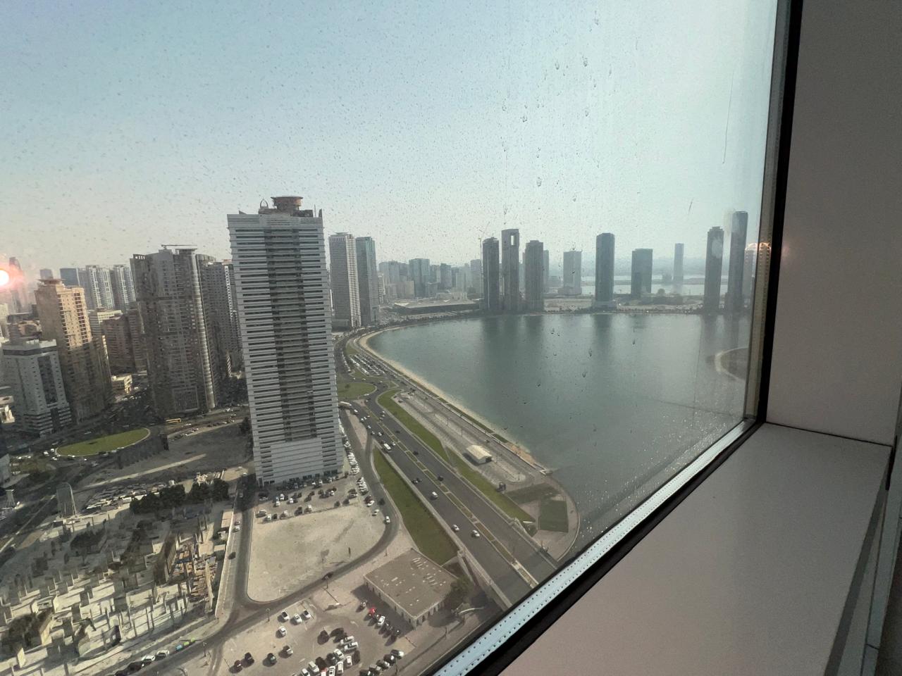 Two-bedroom apartment with balcony and free AC in Al Qasba Khan, open view, gym and pool, flexible payment options available.