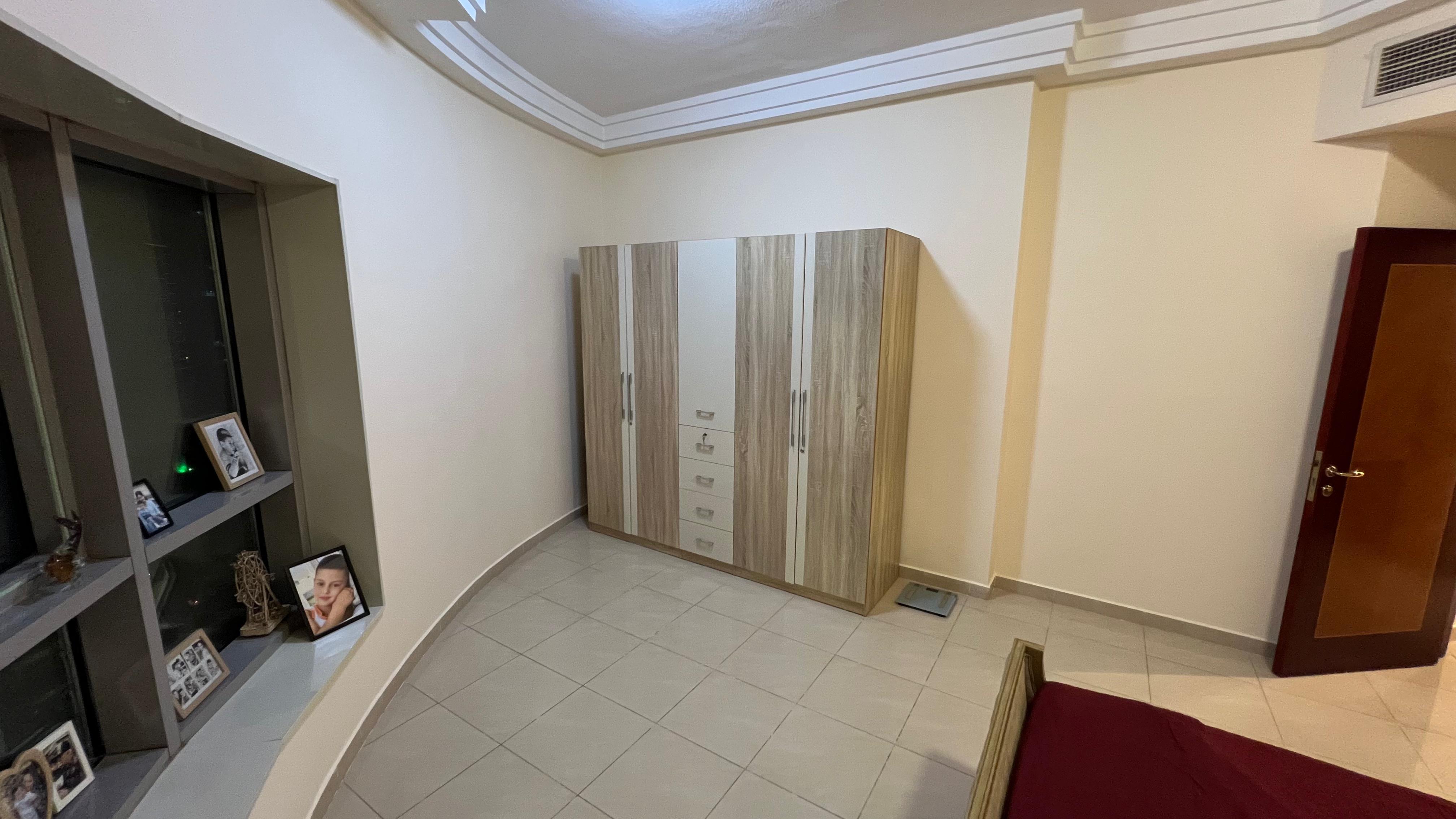 3-bedroom apartment with maid room for sale in Conqueror Tower Ajman. Freehold, city view, rented, closed kitchen.