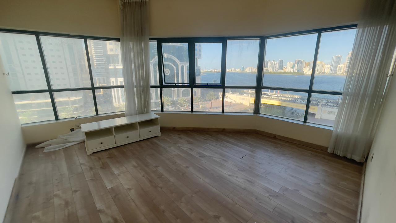 Three-bedroom apartment in Al Majaz 3 Al Qasba with parking, full sea view, panoramic windows, very clean, fully maintained.