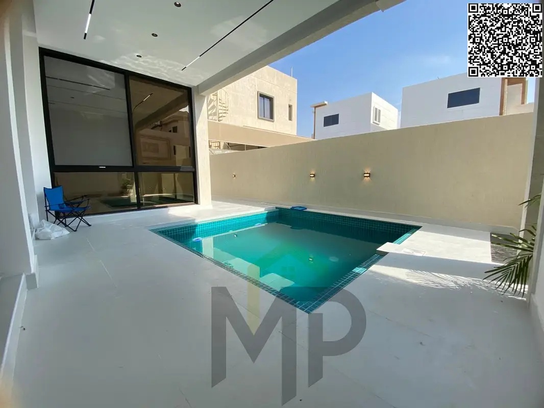 A luxurious two-story villa with a rooftop terrace, gardens, and spacious outdoor areas in the Al Bahia area. Freehold ownership is available to all n