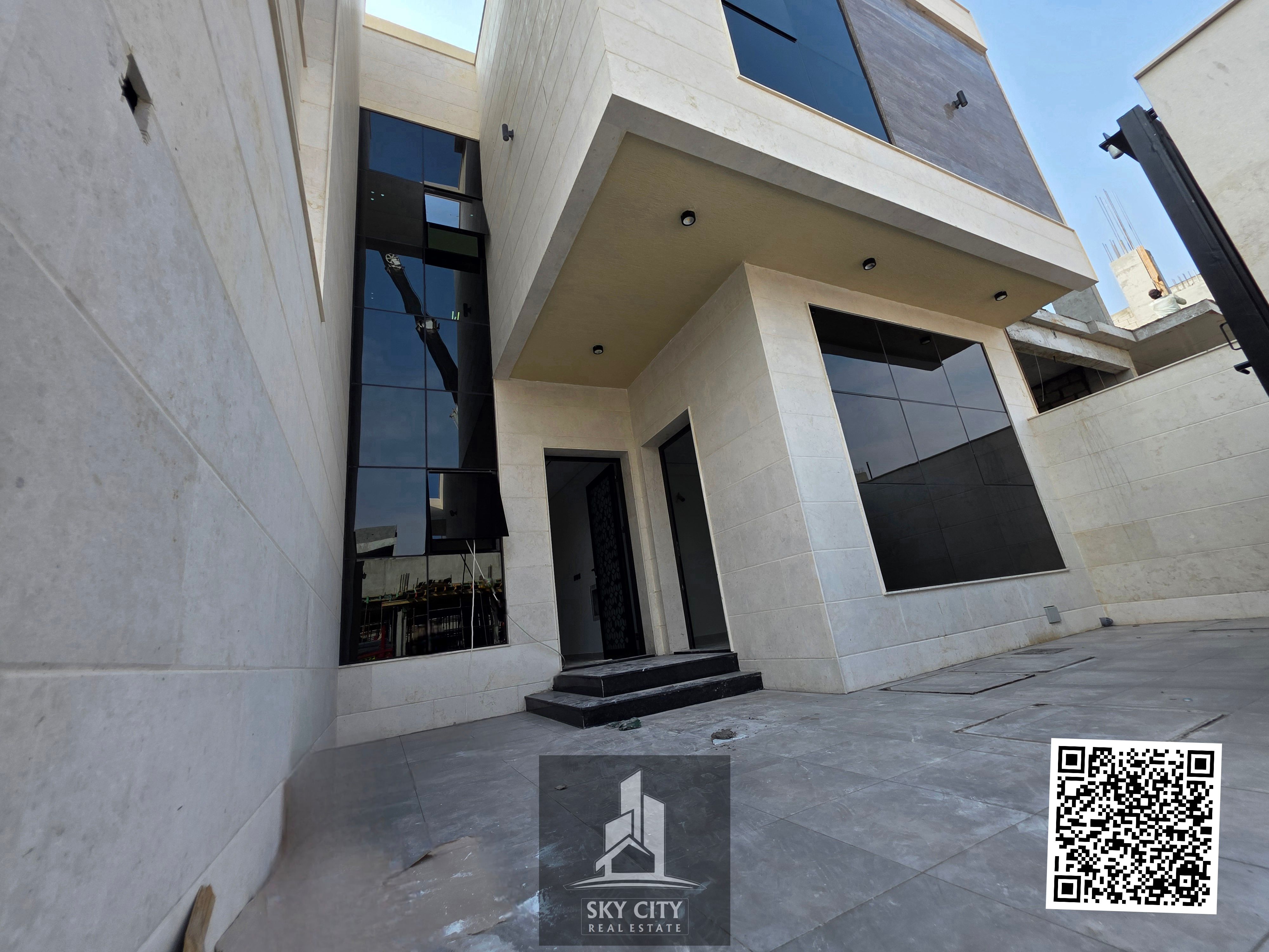 Al-Haliyo, Ajman, behind Emirates Towers. 5 master bedrooms, majlis, living room, maid's room. Ground floor, first floor, and roof with terrace. Includes registration and ownership fees. Freehold ownership for all nationalities.