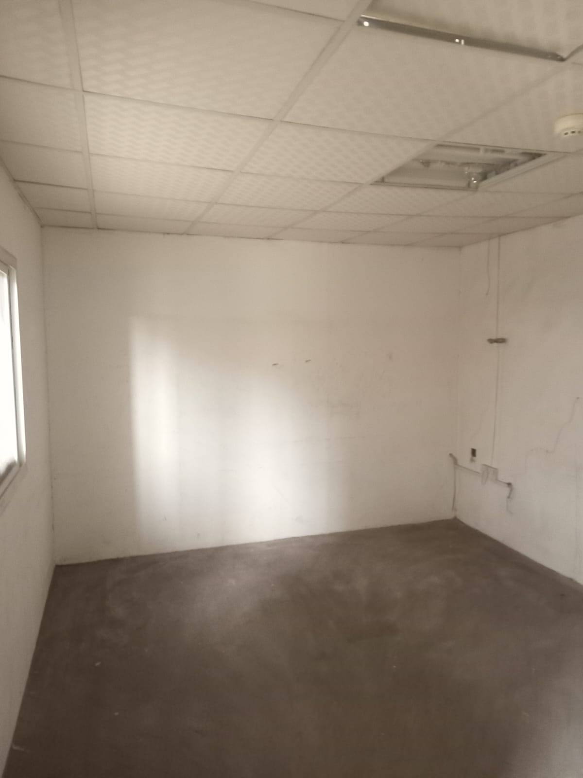 Commercial warehouse in Ajman 1200 sq ft with 3-phase electricity on main road suitable for business.