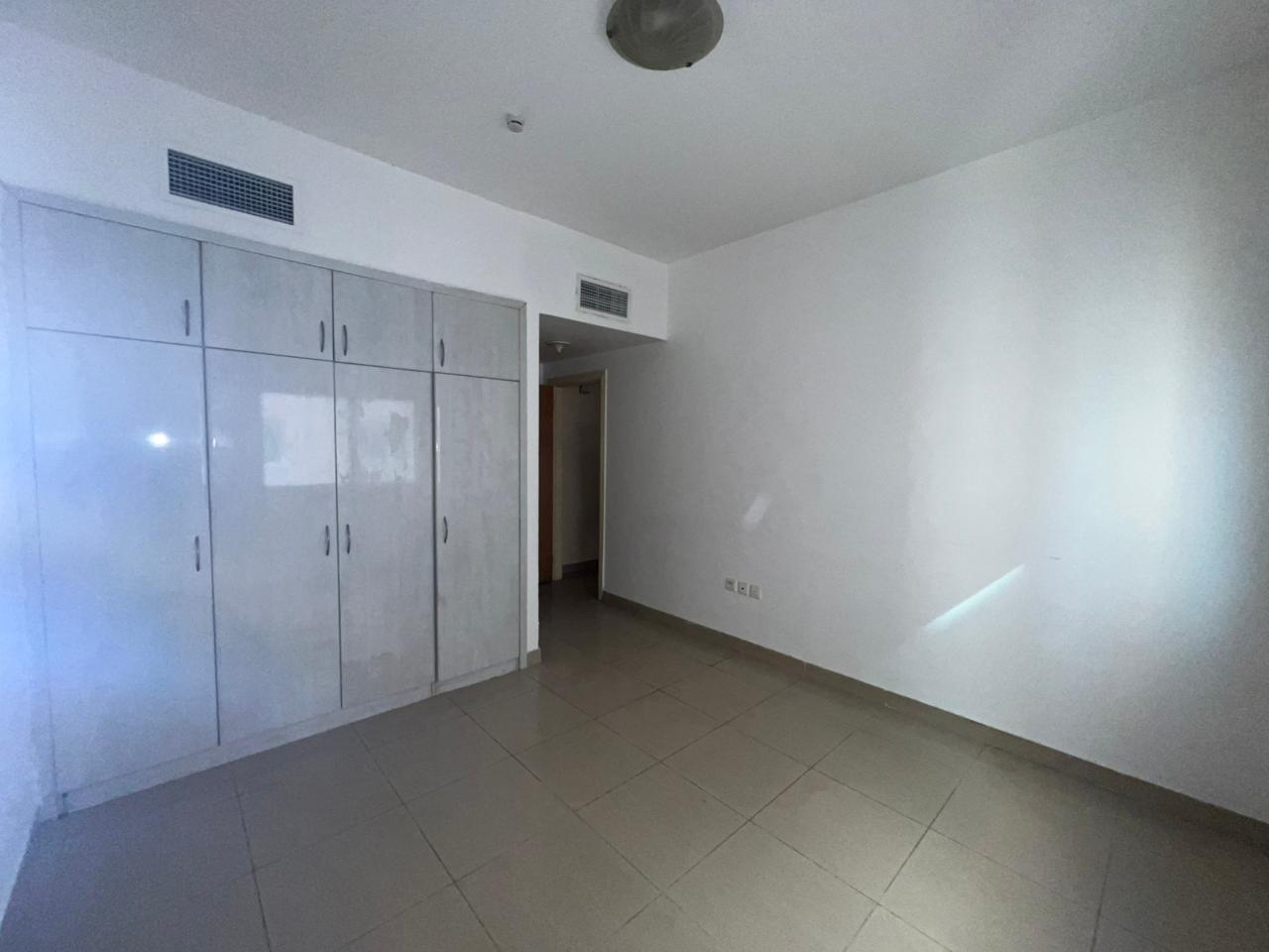 Two-bedroom apartment in Al Nahda Sharjah with balcony, closed view, master bedroom, built-in wardrobes, delivered after full maintenance.