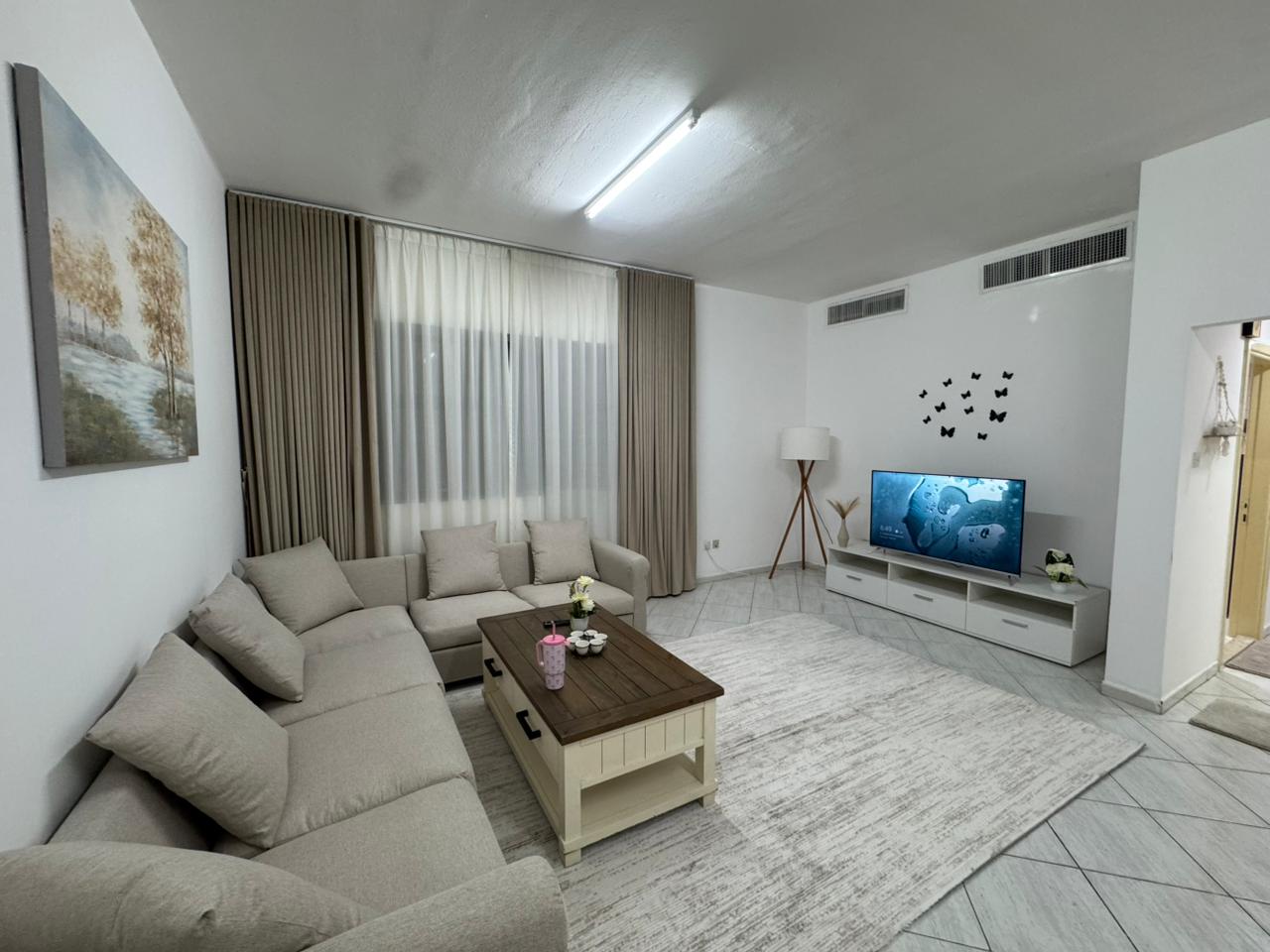 Two bedrooms and a living room, brand new furniture, first occupancy, Al Rashidiya area