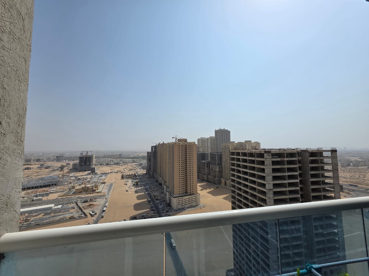 2-bedroom apartment in Golf Tower Ajman, high floor, free AC, balcony with open city view, ready to move in.