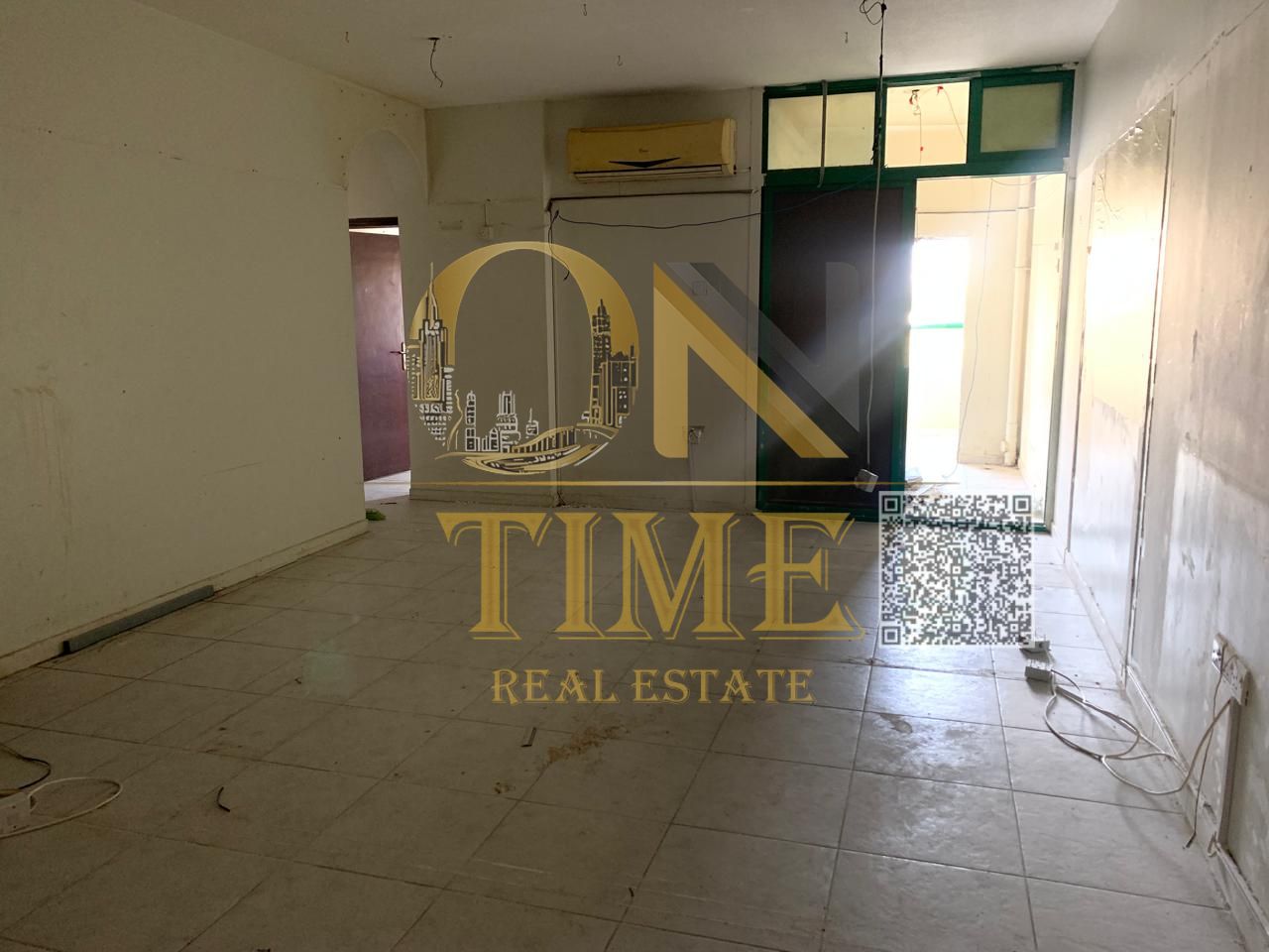 Two-bedroom unfurnished apartment with a spacious living room and a prime location for monthly rent, including bills and internet.