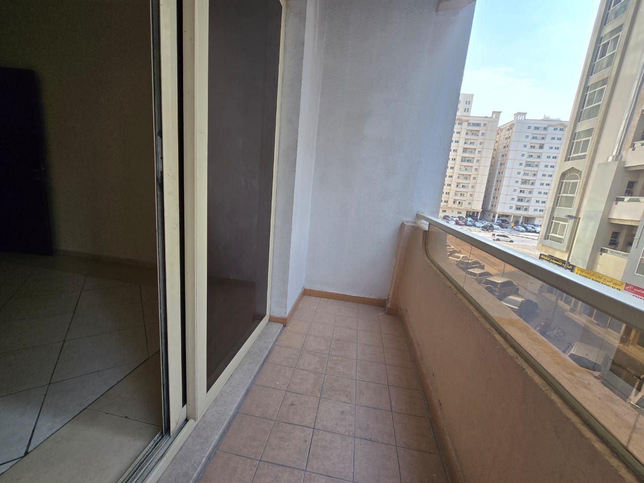 Spacious one-bedroom apartment with balcony in Al Qasimia Al Nad, bright layout, direct Dubai exit, close to all services.