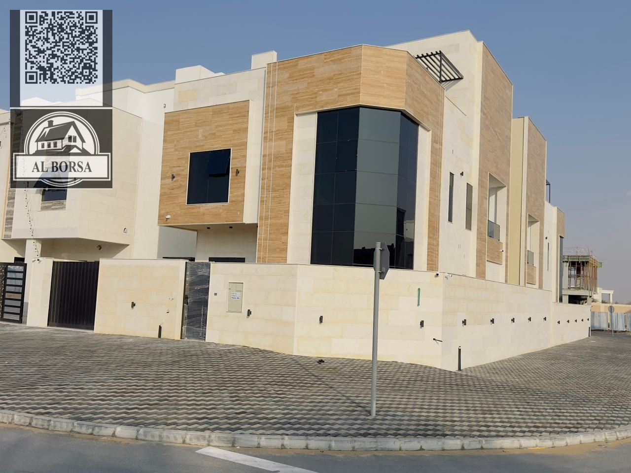 For sale in Al Helio 2, Ajman: Corner villa with 6 master bedrooms, a majlis, a living room, a spacious kitchen, and a maid's room.