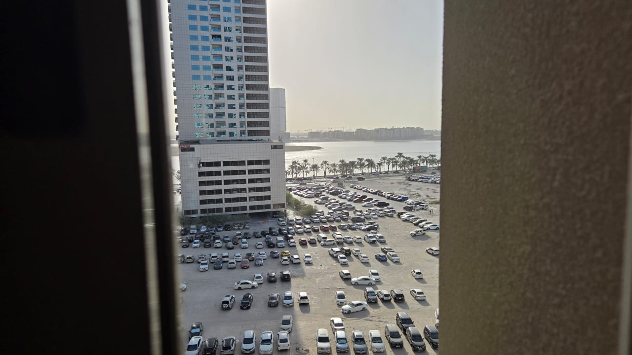 2BR apartment in Sharjah Al Khan with central AC, 2 bathrooms, sea view, near services and Dubai exit, flexible payment via Tabby, annual rent AED 44,