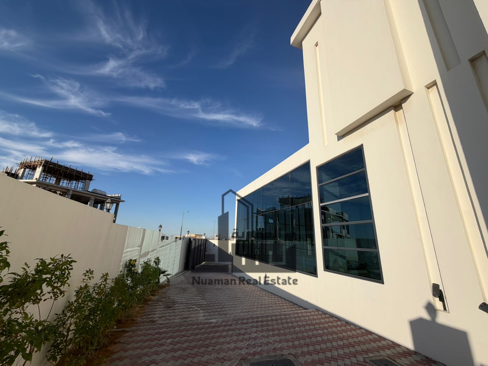 A luxurious villa in Telal City, featuring five bedrooms with a modern design and high-end finishes, spacious areas, a distinctive view