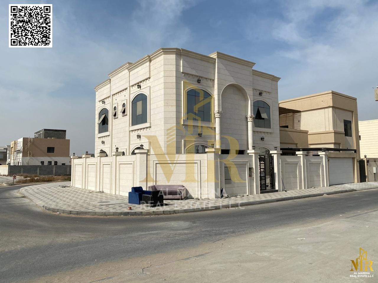 Corner villa in Al Alia area at a prime location, featuring two floors and a roof with a modern design and spacious layout, includes five master bedro