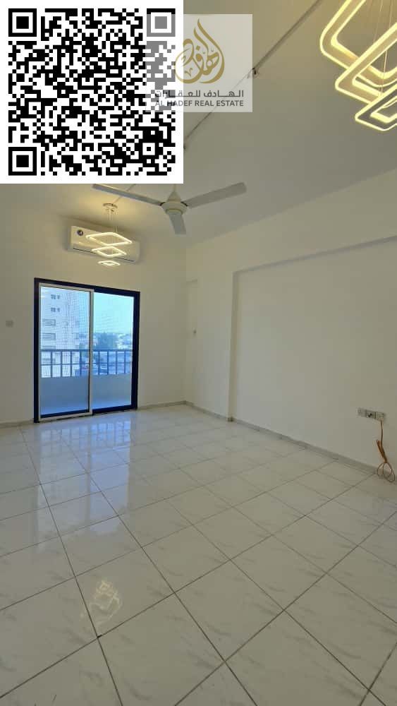 A separate room and living room, a large hallway with a balcony, and two bathrooms in Al Nuaimiya 1, near Emirates Markets.