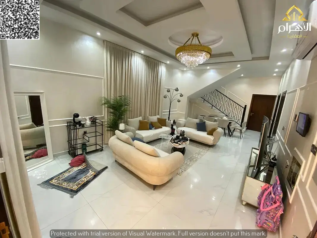 Luxury villa for sale in Ajman, fully furnished and including electricity, water, air conditioning, and furniture. Located on a main street, it featur