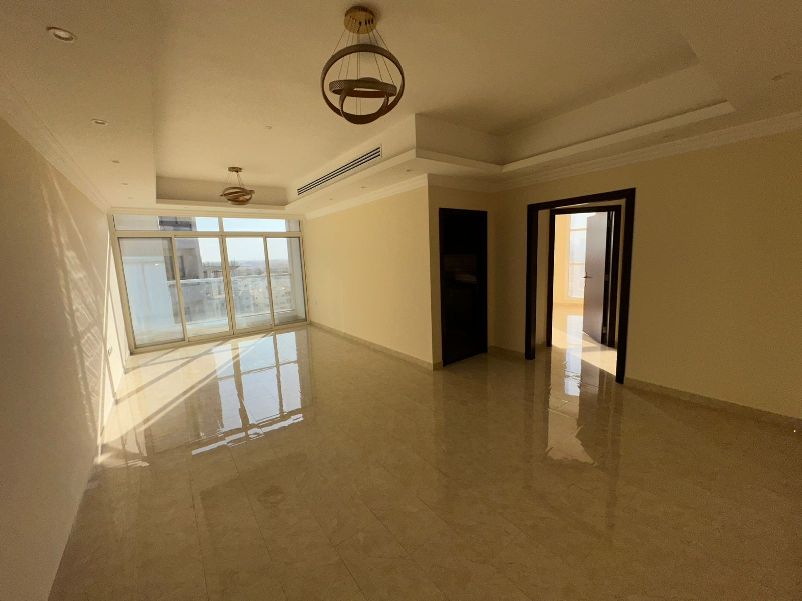 Three rooms and a spacious living room with a large, distinctive open view throughout the apartment.