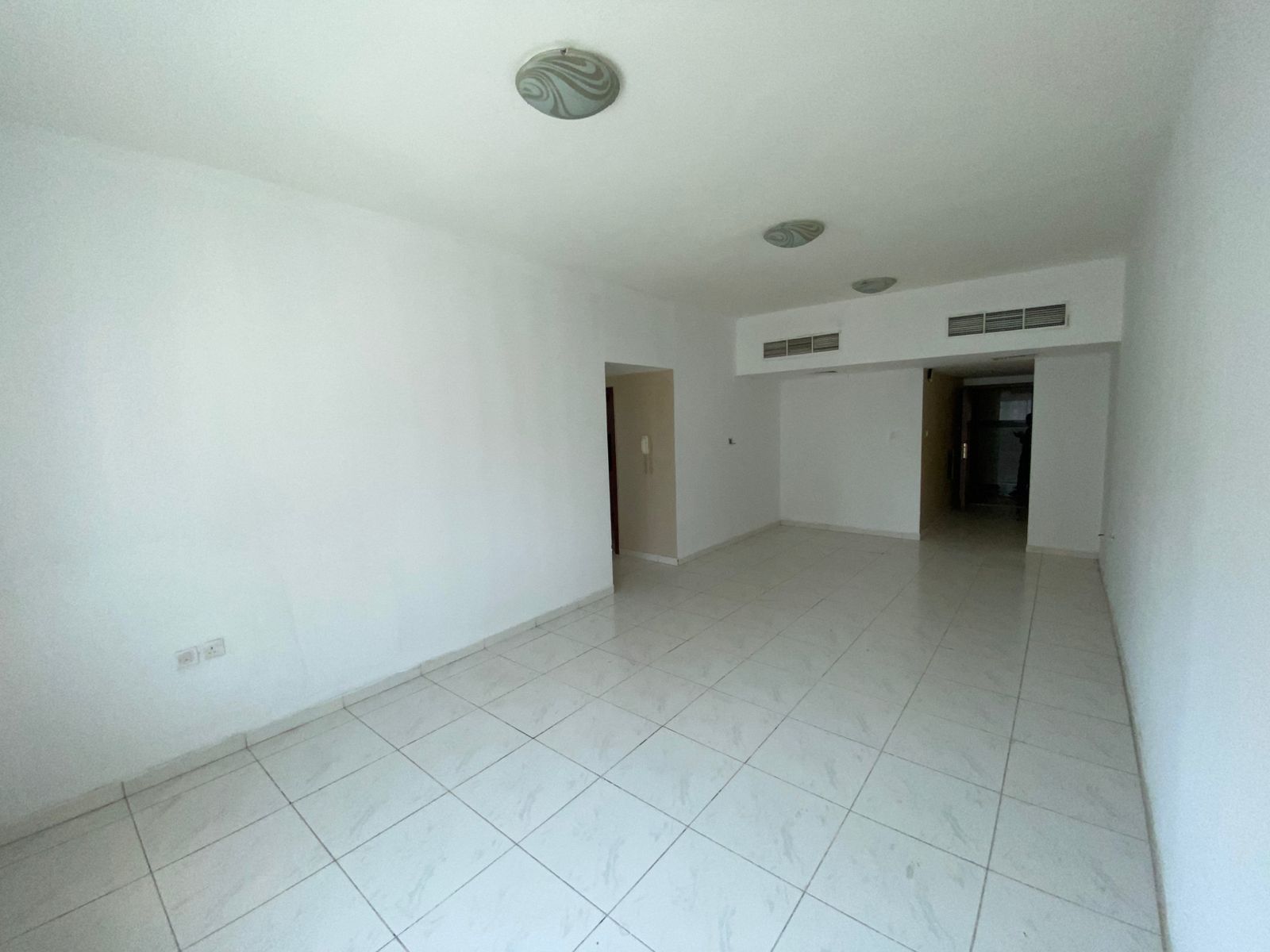 Two-bedroom apartment with a living room in Rashidiya 3, Old Traffic Street, with two balconies and built-in wall cabinets, close to Ajman Corniche an