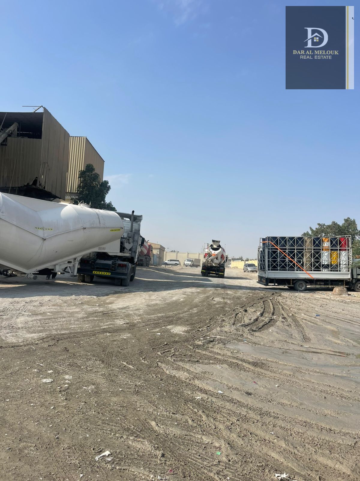For sale in Sharjah, Al Sajaa area: A 20,000 sq ft plot of land. It includes a large canopy, a fence, a bathroom, a kitchen,