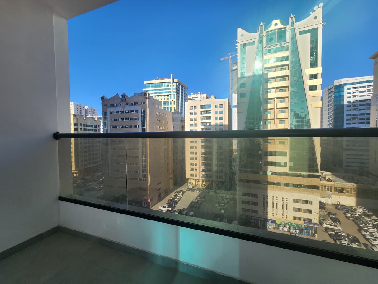 Two-bedroom apartment with hall in Al Khan, second tenant, master rooms, large balcony with city and sea views, parking, 3 bathrooms, close to Dubai,