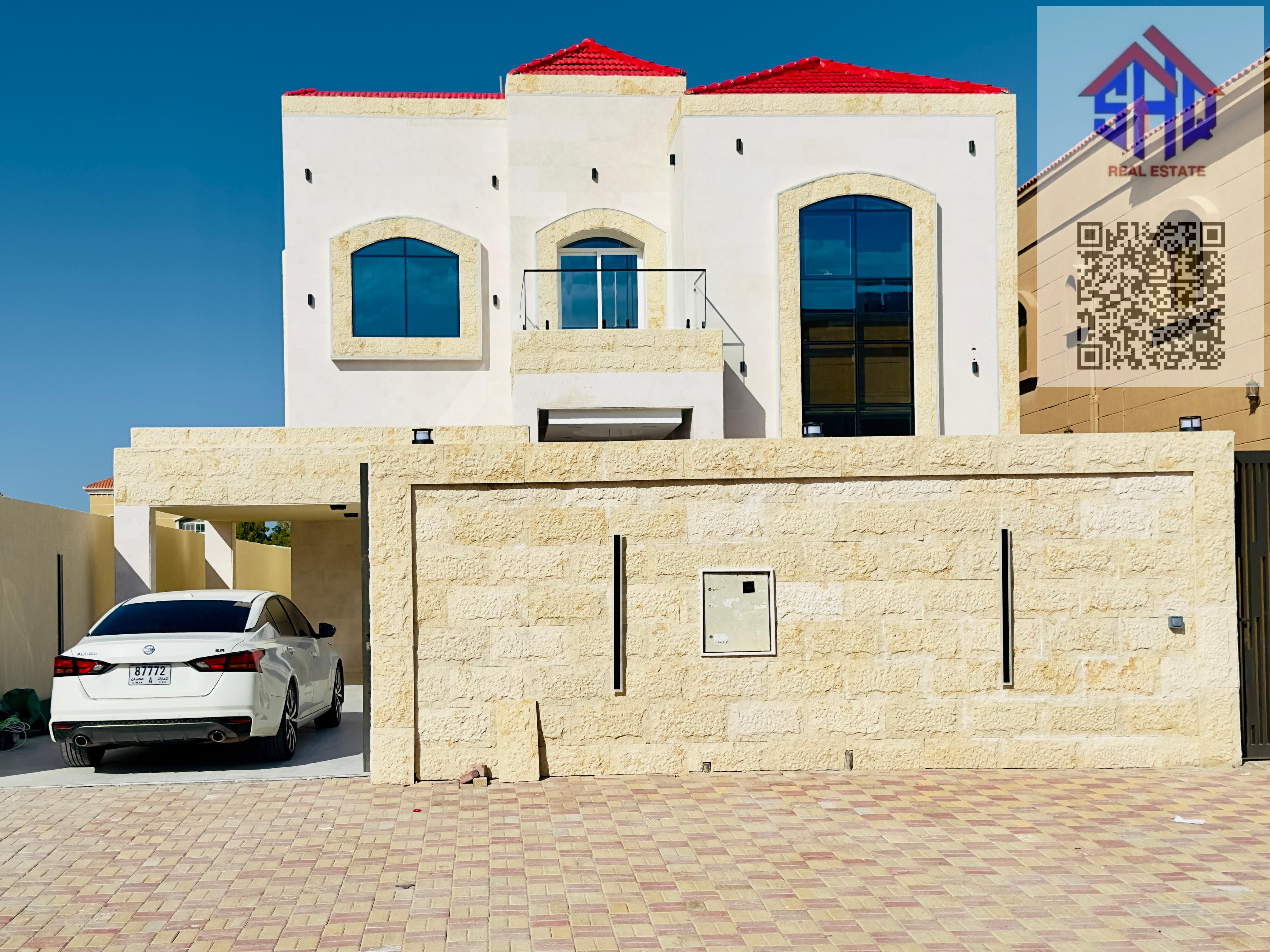 Villa for sale in Al Muwaihat area, including water, electricity, and air conditioning. Five rooms, living room, maid's room, regular kitchen, and preparation kitchen.