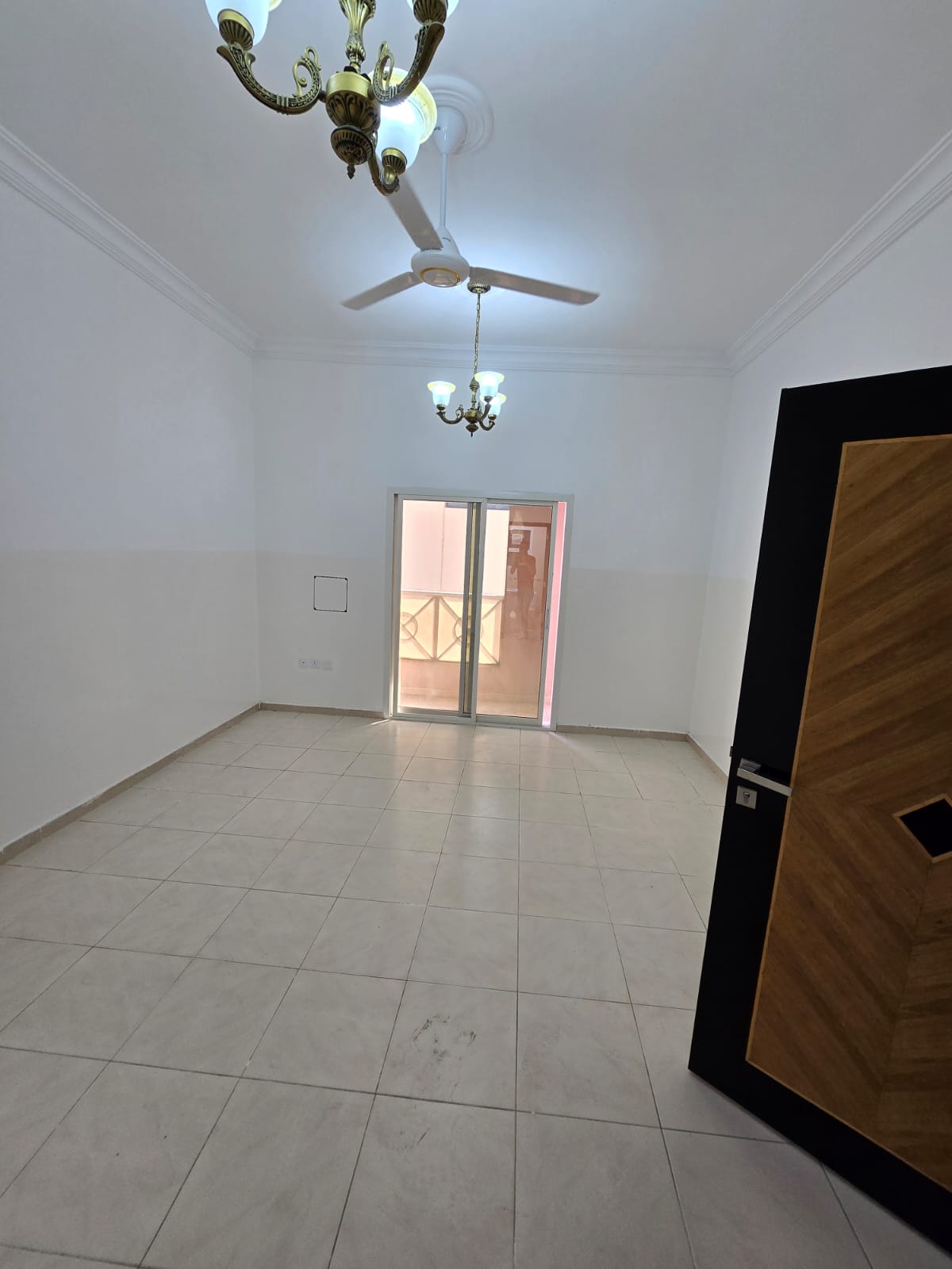 A two-bedroom apartment with a living room, two bathrooms, and a balcony in Al Naeemiyah 1 on Al Ittihad Street, next to Emirates Markets, close to DT