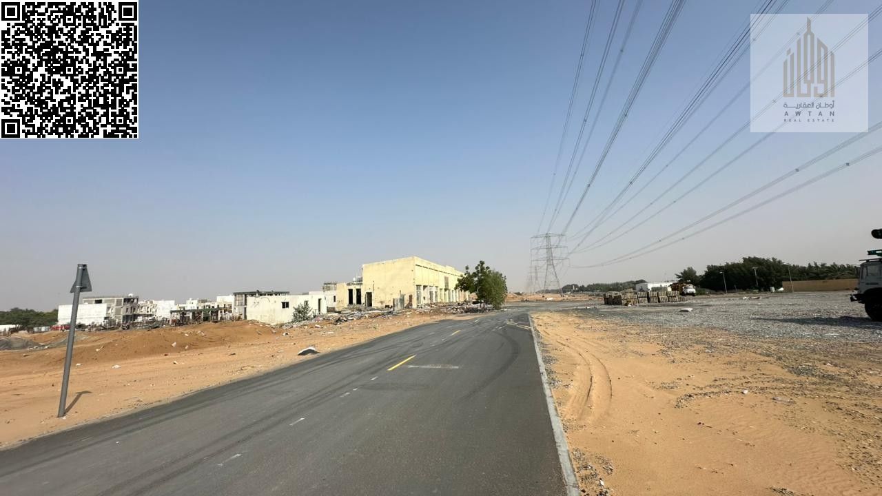For sale: Residential-commercial land in Ajman Emirate, Al-Helio 2 area, directly on Al-Zubair Street, with both front and back streets. The plot cove