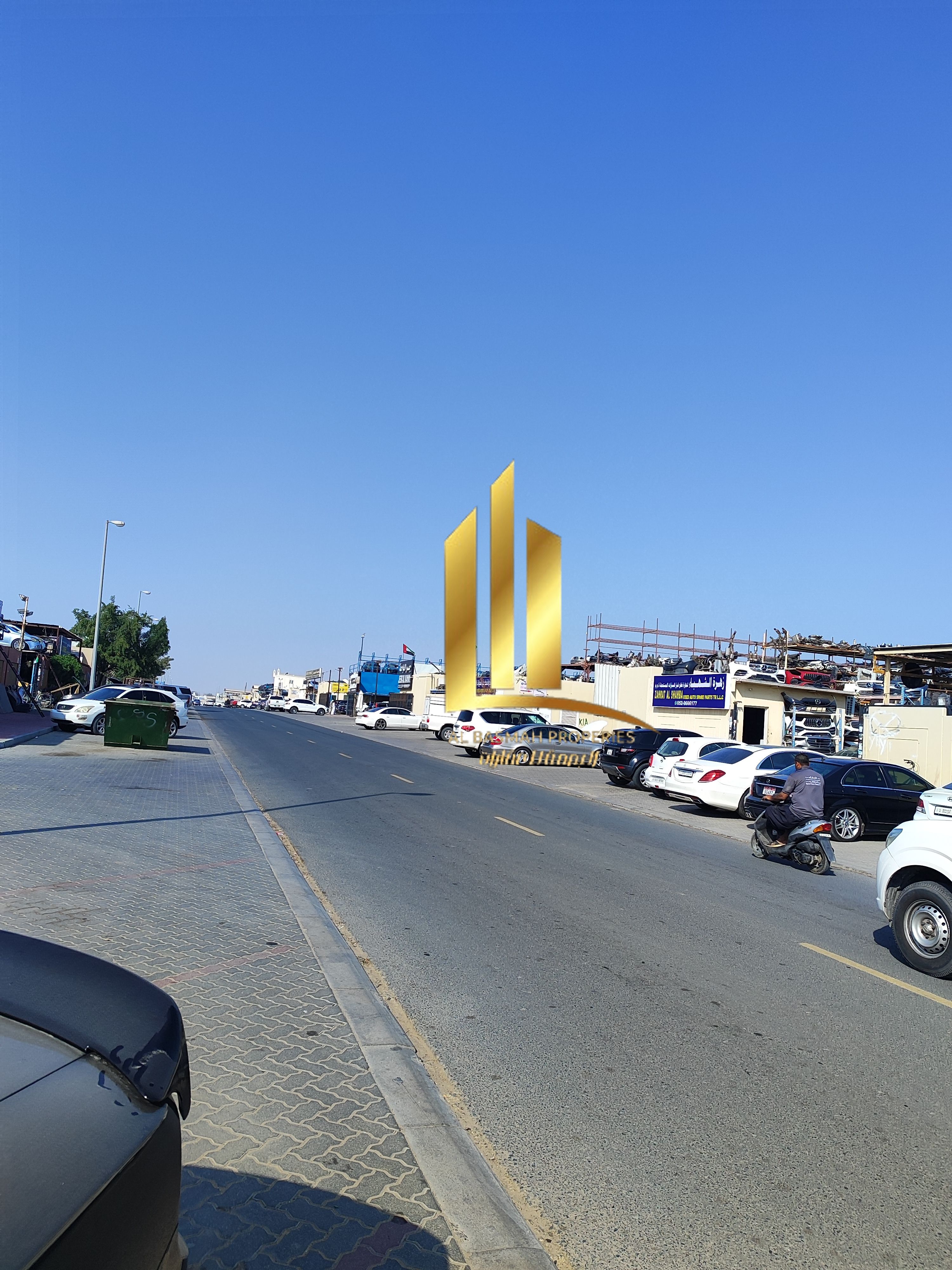 A fenced plot of land for sale inside the scrap yard in Al Sajaa, Emirates Industrial City, Block 6