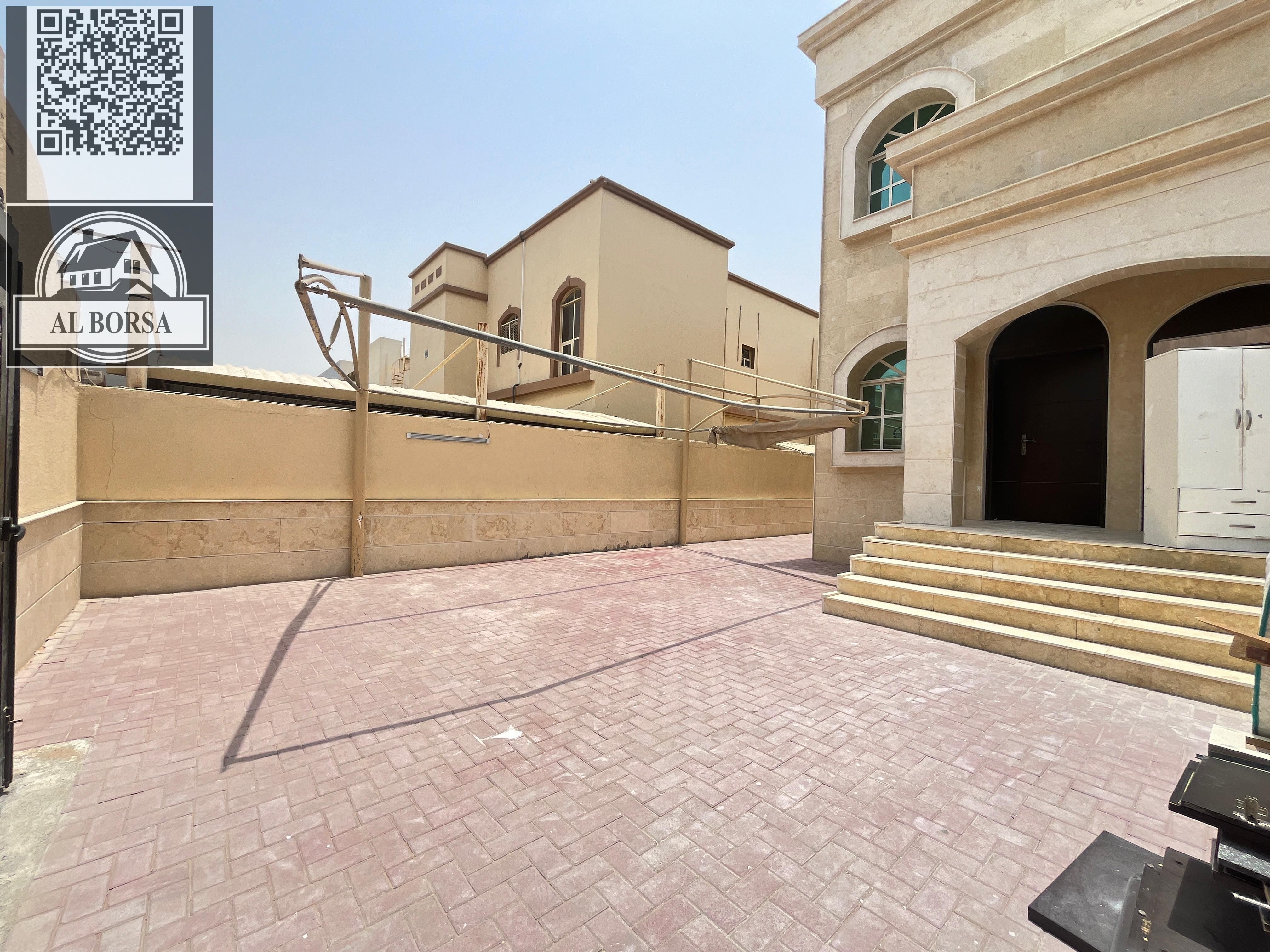 For annual rent, villa in Al Muwaihat 3 - Ajman, 5 rooms + hall + majlis + large yard and external setback + parking, local electricity, ready to m