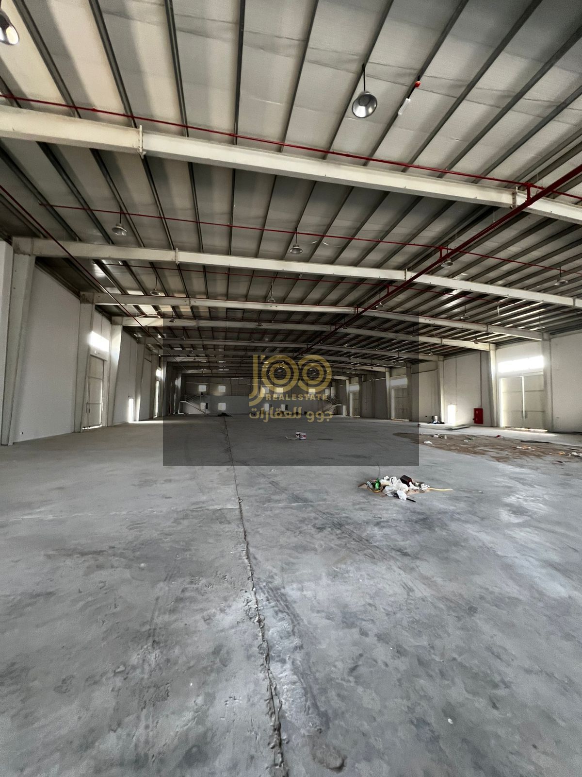 Spacious warehouse in Umm Al Thaub, Umm Al Quwain, ideal for storage or business, secure area, easy access, high ceiling, and wide entrance.