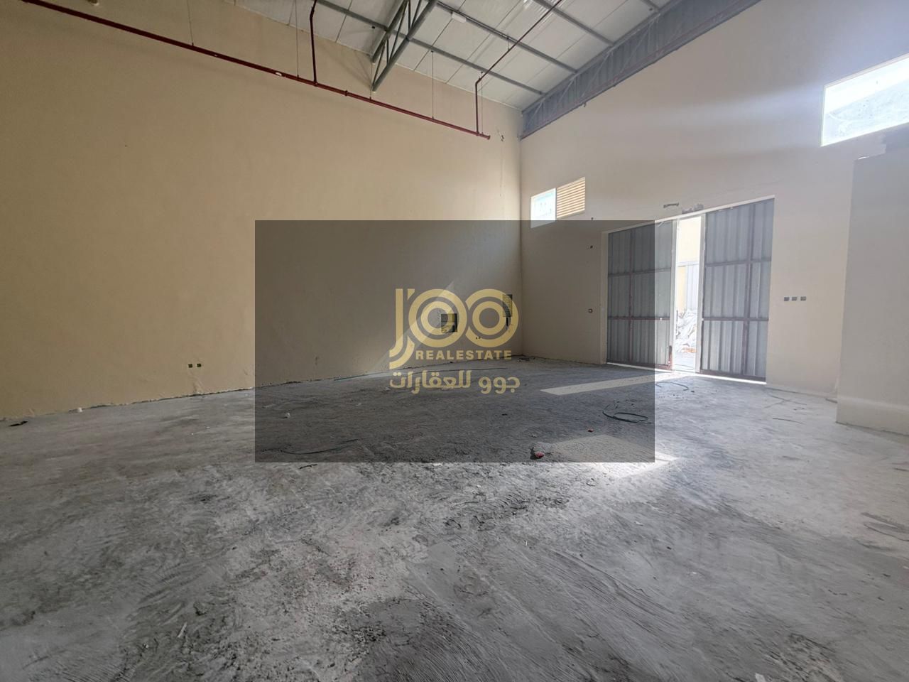 A prime warehouse is available for rent in the Umm Al Thu'ub area, featuring a spacious area that allows for easy movement of cranes and vehicles.