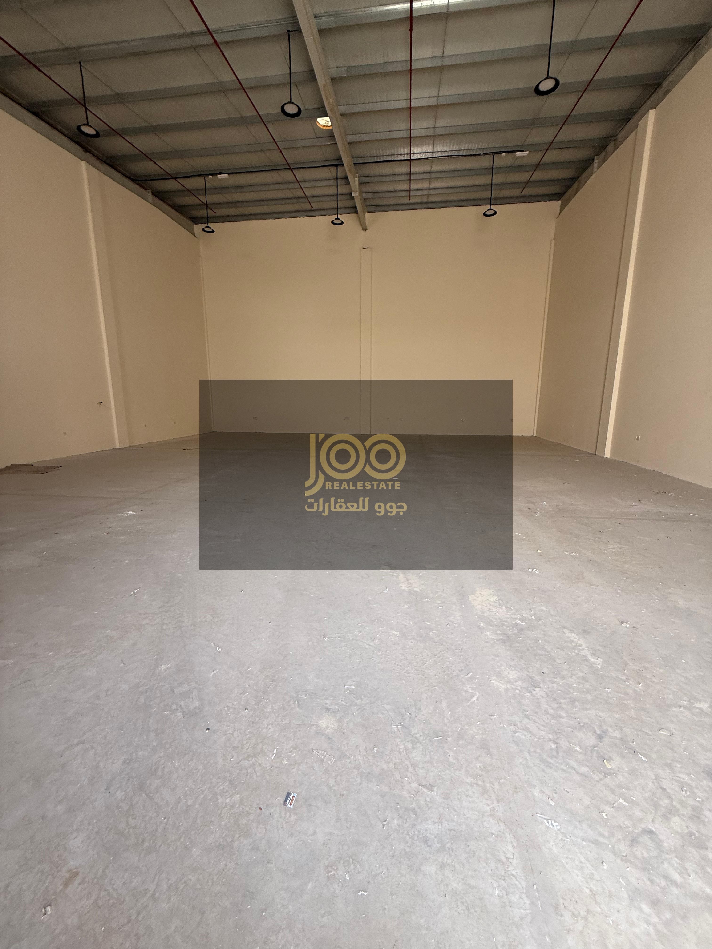 Two adjacent warehouses for rent in Umm Al Thu'ub, offering practical storage space that helps organize business and saves space.