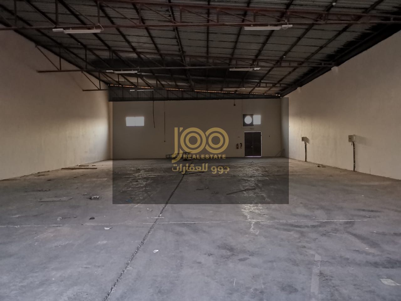 Warehouse for rent in Umm Al Quwain, in the industrial area, equipped with a strong floor and high ceiling allowing for easy movement and storage.