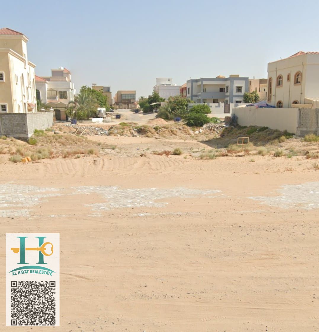 Residential and commercial land, corner of a street and alley in Al Muwaihat 1, directly on the camel racecourse, freehold for all nationalities
