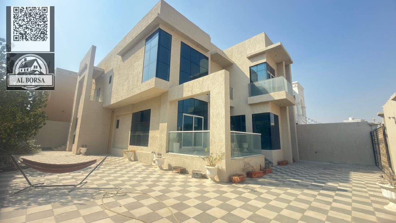 Villa for rent in Al Helio 1 - Ajman, 4 rooms + Majlis + 2 halls + Maid's room and laundry room + Large yard, Central air conditioning, Citizen ele