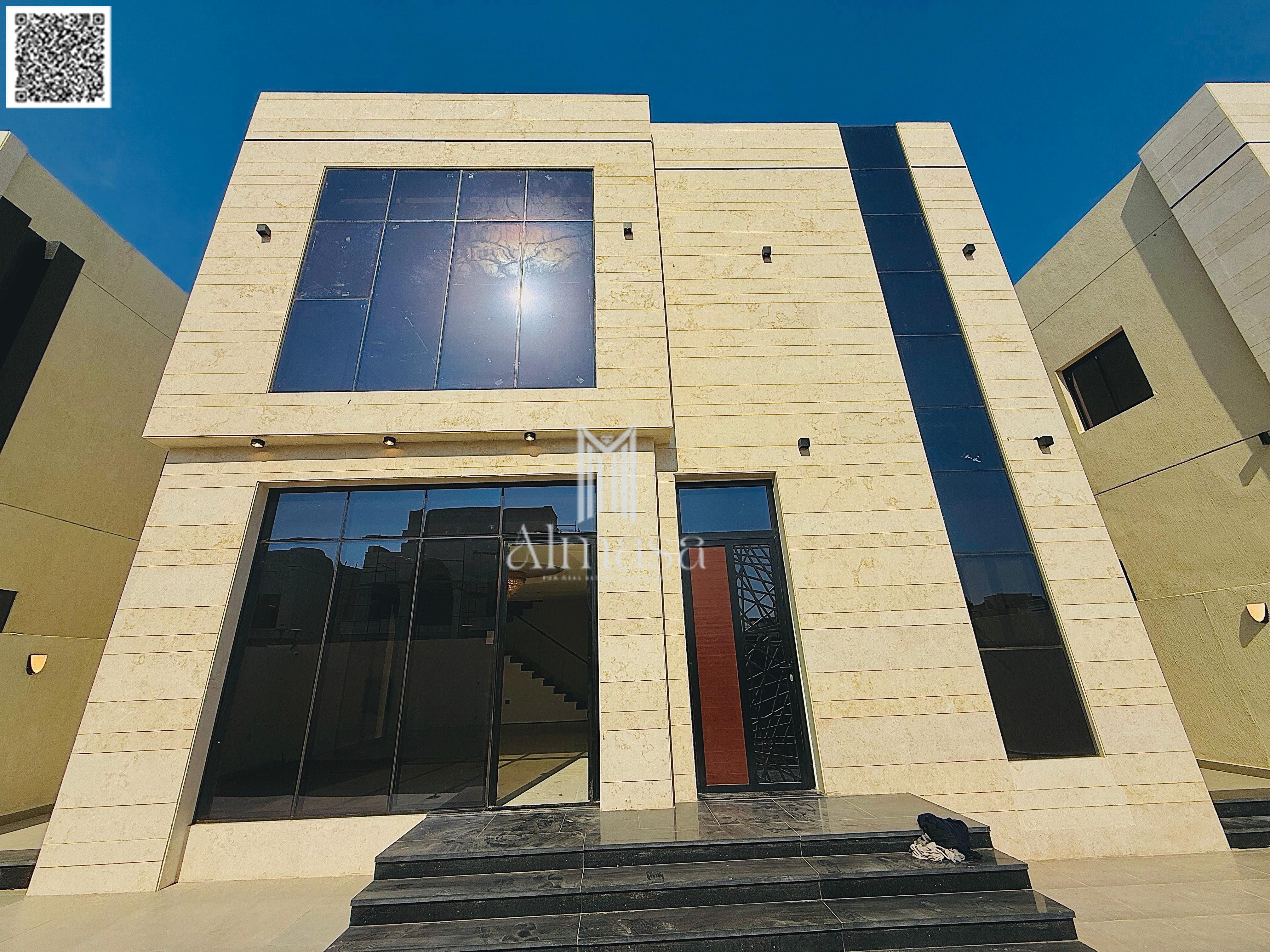 Modern white stone villa located in Al Hadaiq Project – Al Helio, offering a quiet and private living environment with a prime