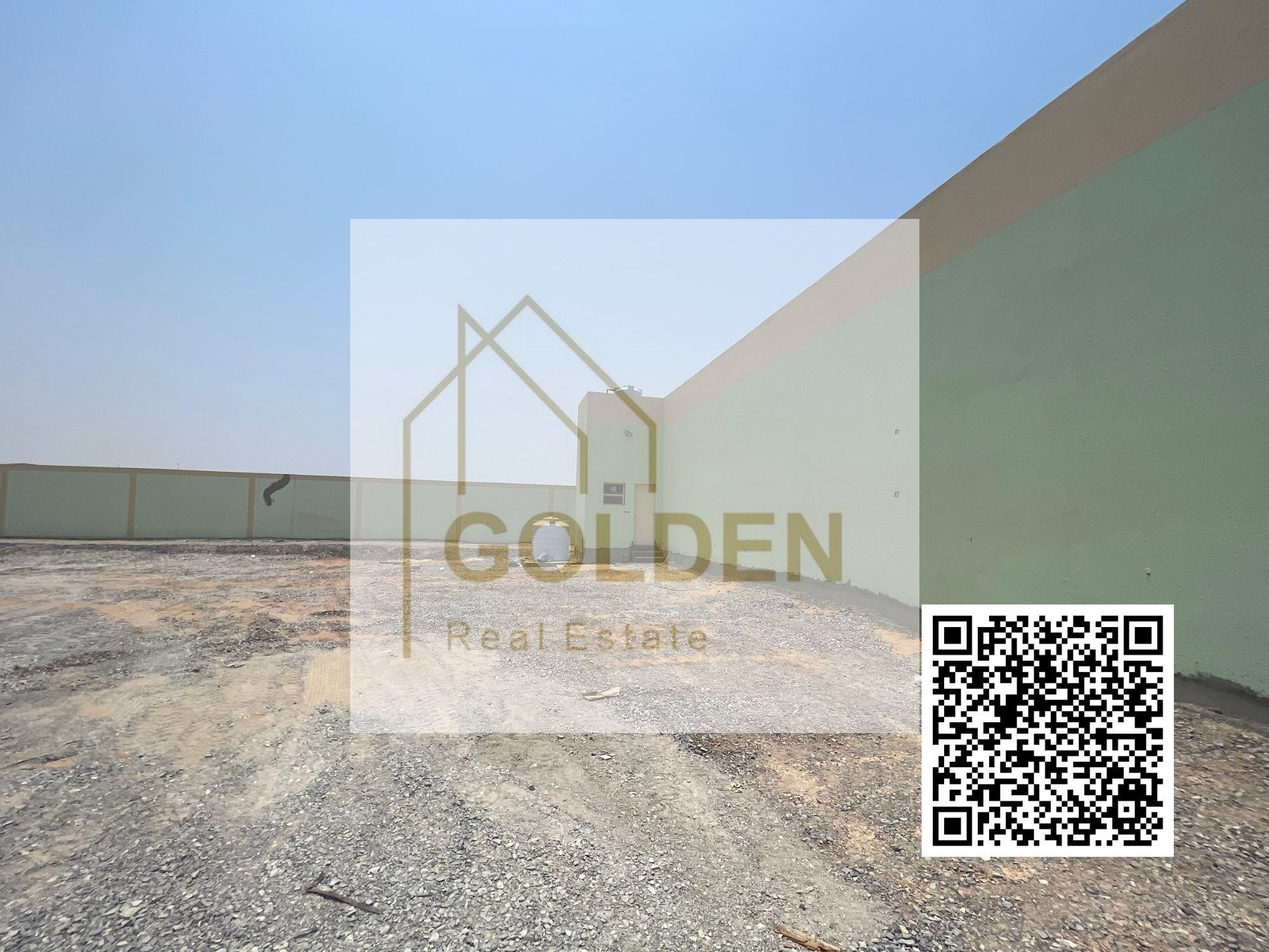 Road-facing open yard with fencing, located on a prime 2-road corner plot, offering easy access for loading and offloading in Umm Al Quwain.