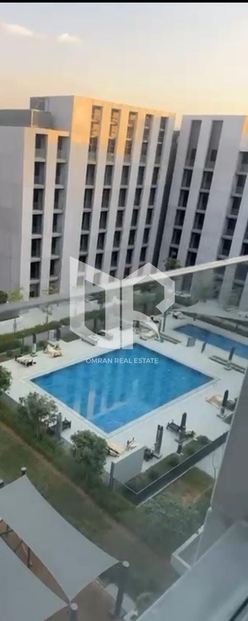 Invest with peace of mind… Rental apartment with a pool view in Al-Jada