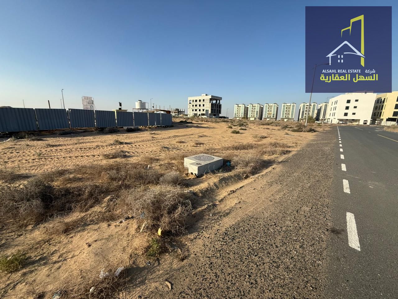 A distinguished corner residential plot for sale in Tilal, Sharjah – Al Suyoh Suburb, ideally located on Street 18 with a 6-meter service lane, offeri