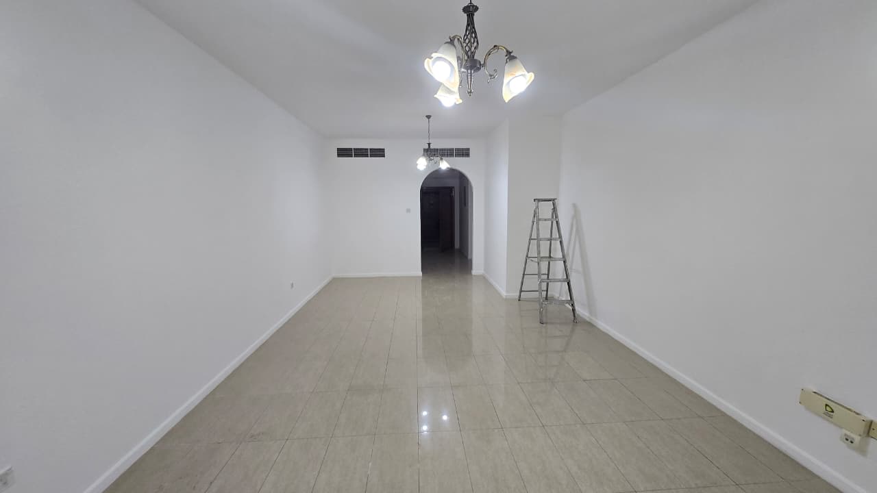 Two-bedroom apartment with living room in Al Majaz 2, two master bedrooms, three bathrooms, built-in wardrobes, spacious layout, direct Dubai exit