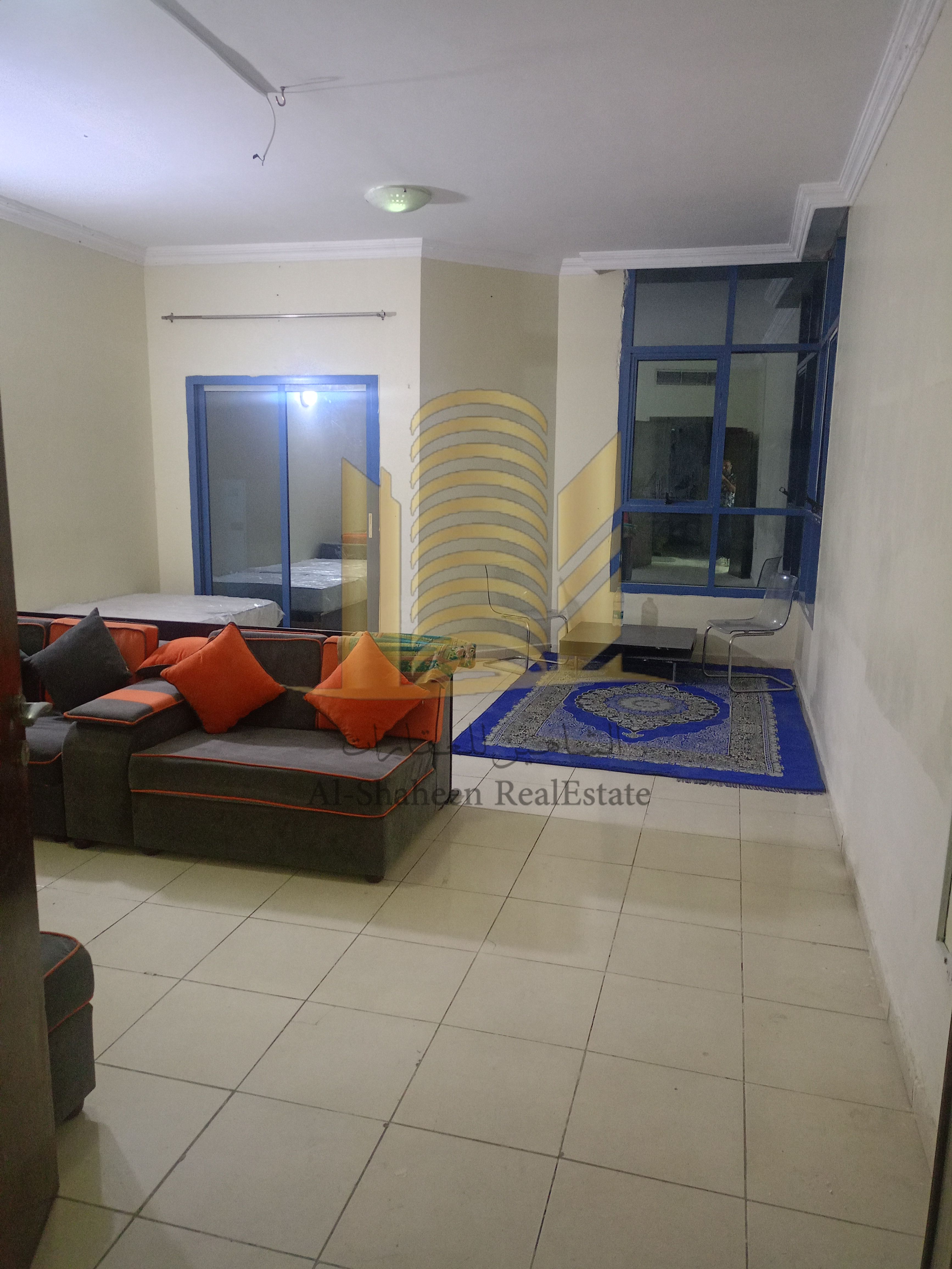 Two-bedroom apartment with a living room for annual rent in Al Khor Towers, Al Rashidiya 1, with a maid's room.