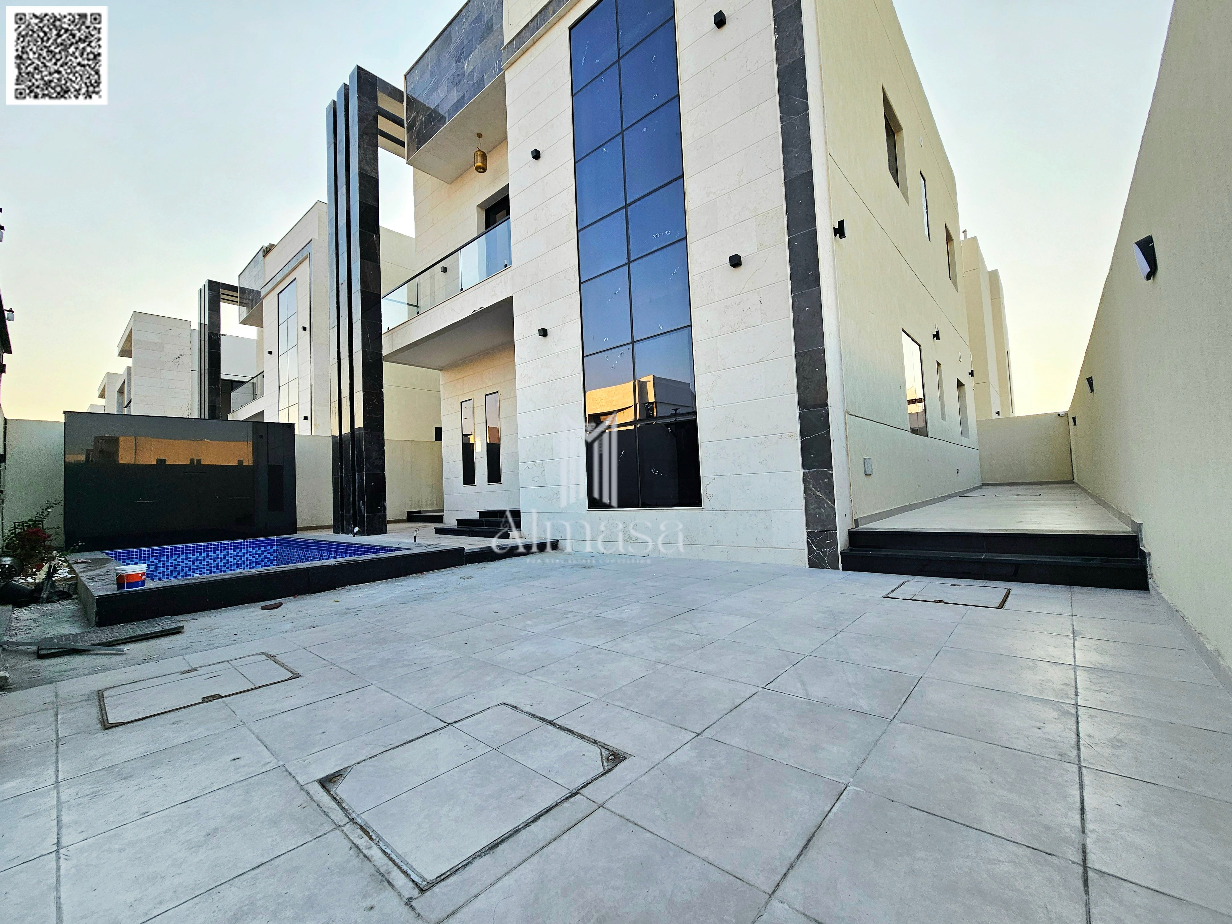 Modern villa with stone facade and swimming pool, registration fees included.