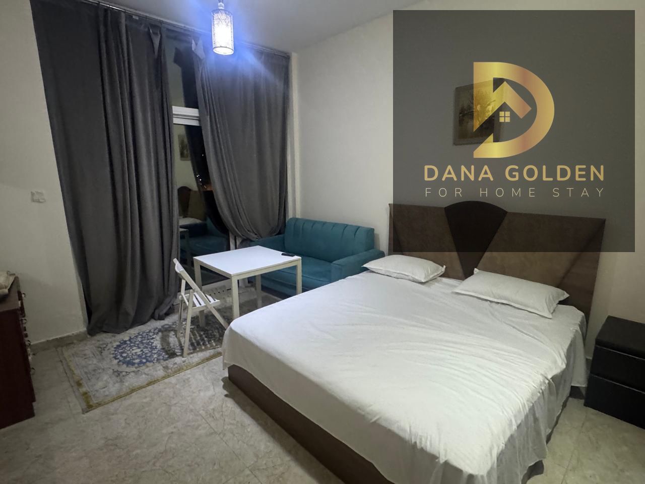 Available today in Dubai Warsan 4 studio with balcony, gym, and parking. Furnished with hotel-style furniture.