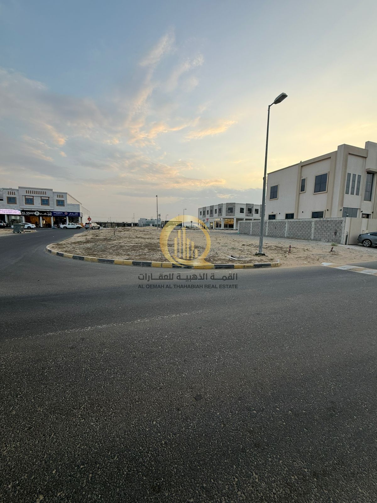 On Mleiha Street, a commercial plot of land is for sale, with an area of 6,000 square feet, located on a corner with three streets.