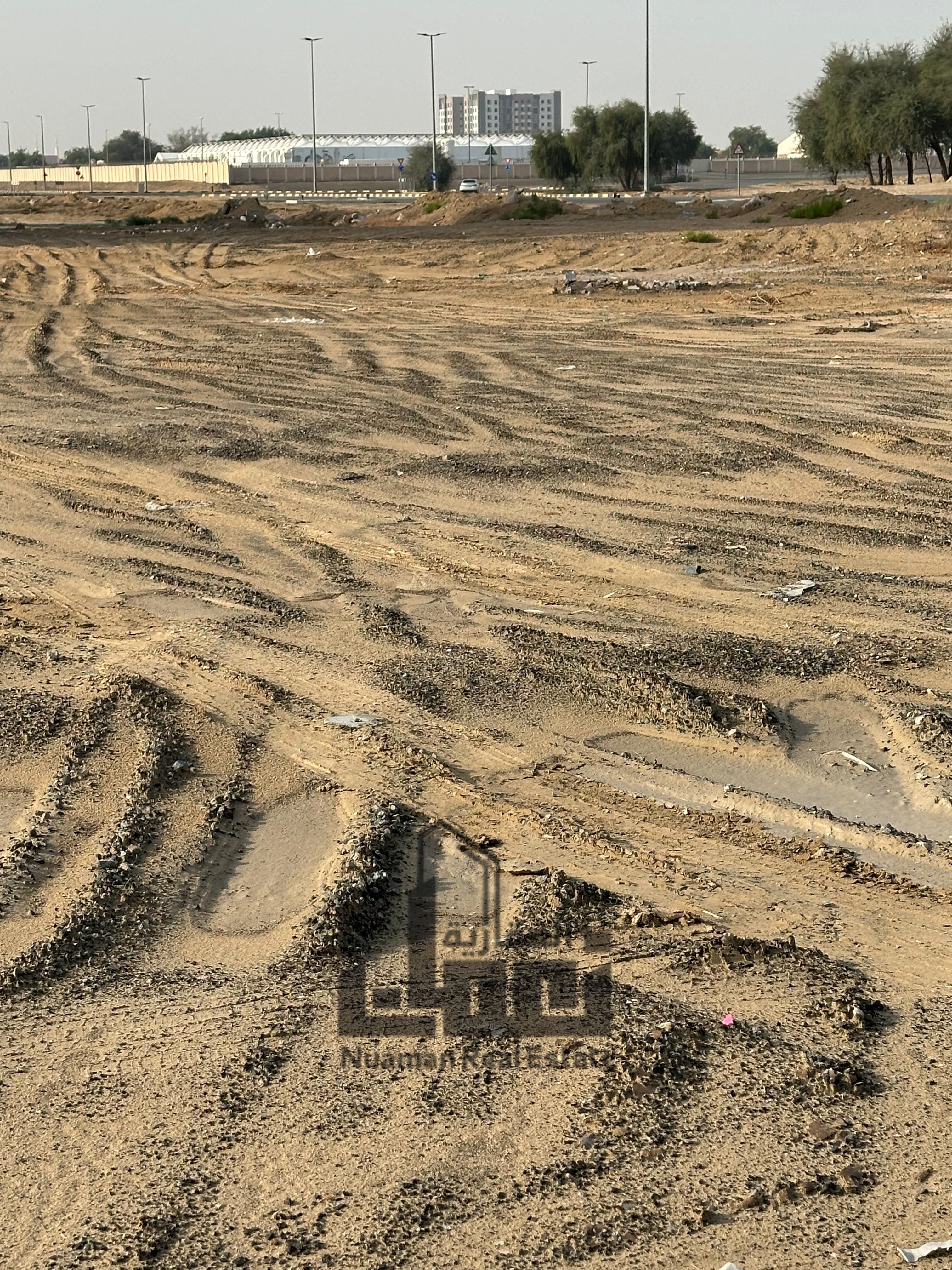 Commercial land for sale in Al Falah – Muweilah Commercial Area, featuring a prime location behind the mosque and the public park