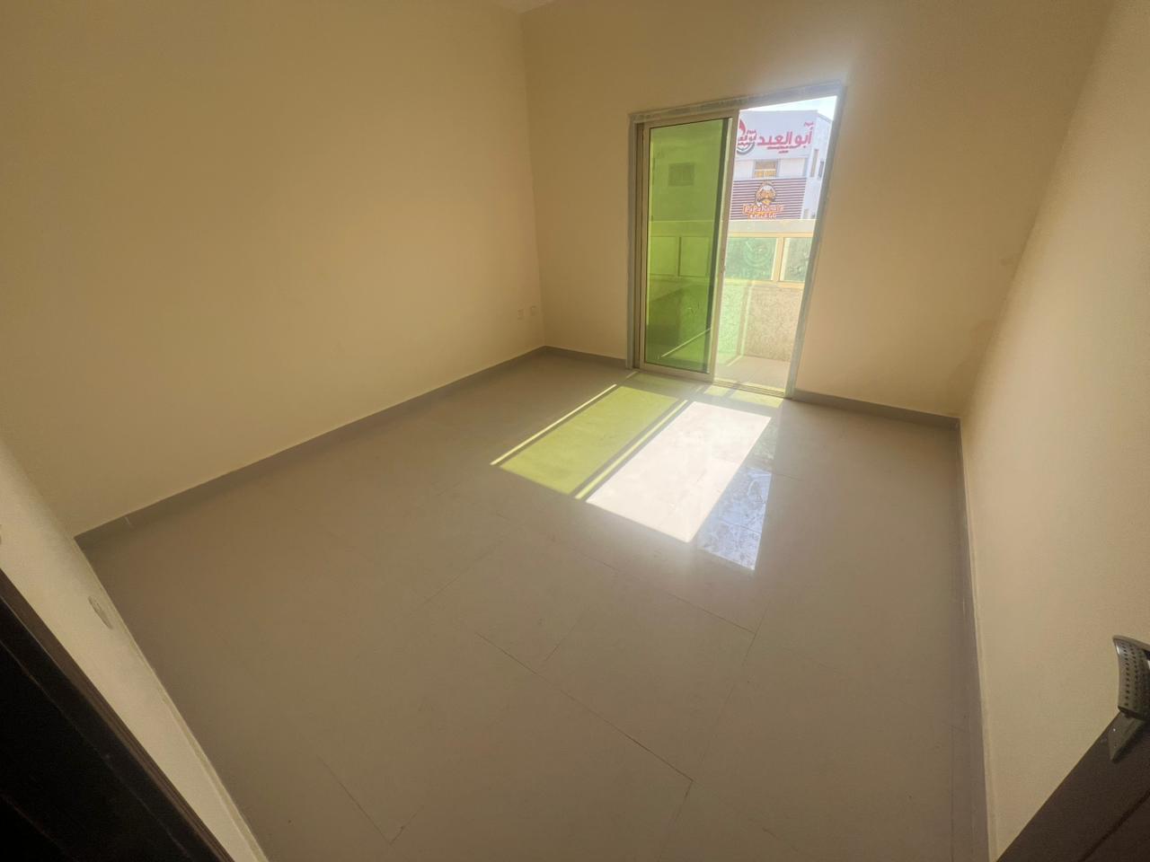 For annual rent in Ajman, a three-bedroom apartment with a living room in Al Rawda 2 area. Features include central air conditioning, two bathrooms, a