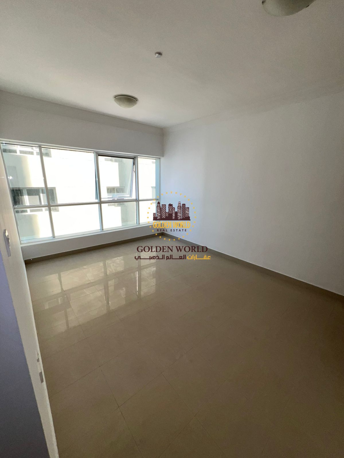A distinctive apartment in Al Taawun, Sharjah, featuring three bedrooms and a living room with a balcony, three bathrooms, built-in wall cabinets, cen