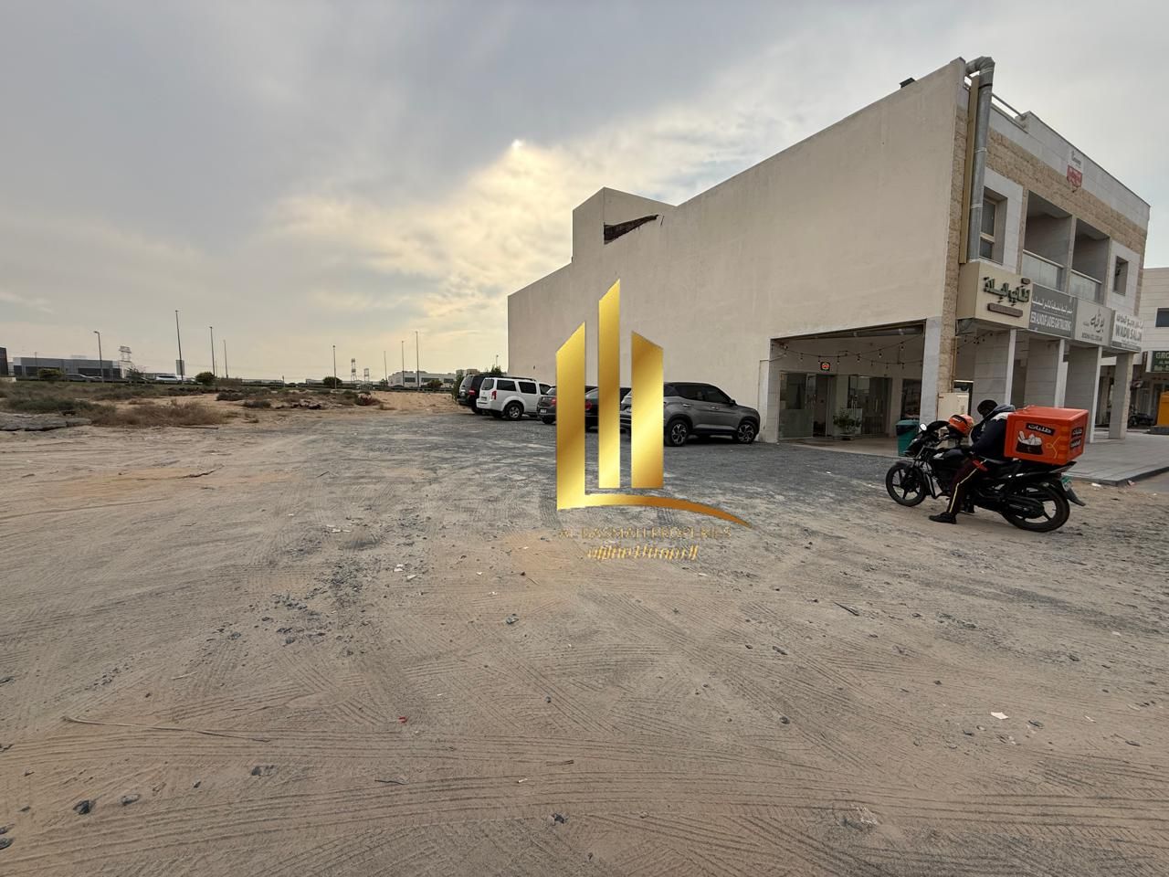 Commercial land for sale in Sharjah, Al-Hawshi, second row, Al-Badi' suburb, freehold ownership for Arab brothers.