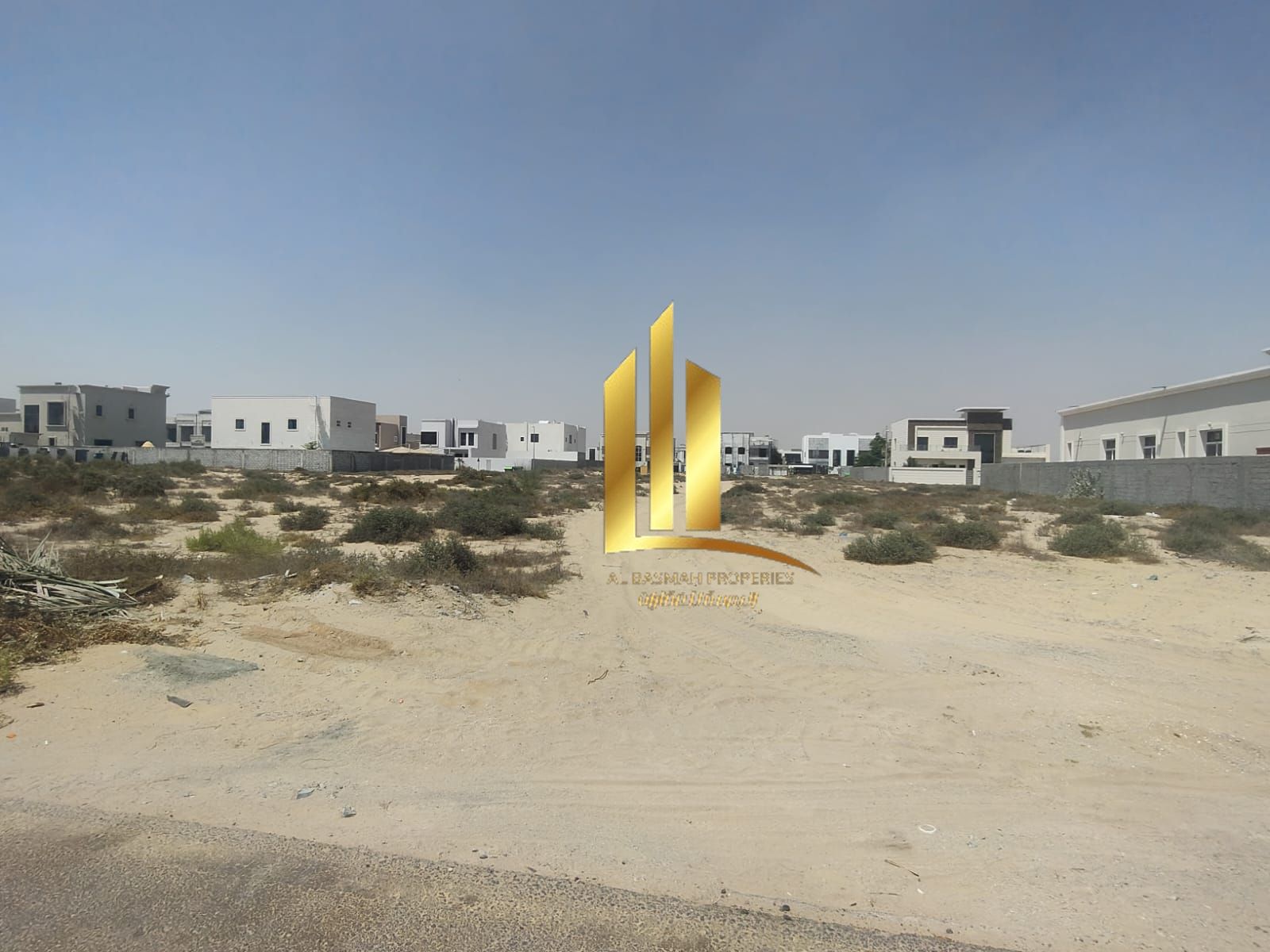 Corner commercial plot for sale, front-facing, near the roundabout in Al-Hawshi, Al-Badi'a suburb, Sharjah