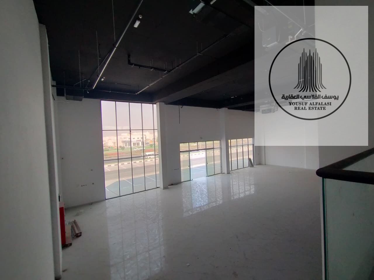 Commercial industrial building with 18 showrooms, offices and parking on a main street.