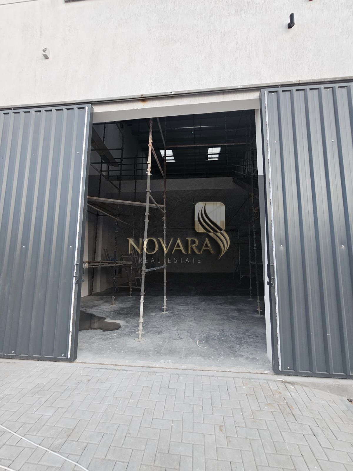 Warehouse for rent in Al Jurf Ind. 3, 3,000 sq. ft with mezzanine, 12m height, 62 kVA power, dual-side road, AED 175k