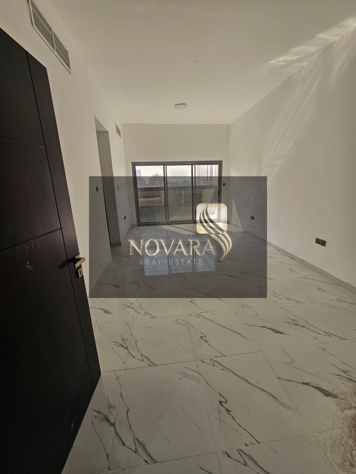 First occupancy apartment in Al Jurf Industrial Area 3, one bedroom and living room with two bathrooms, modern design in a strategic location, priced